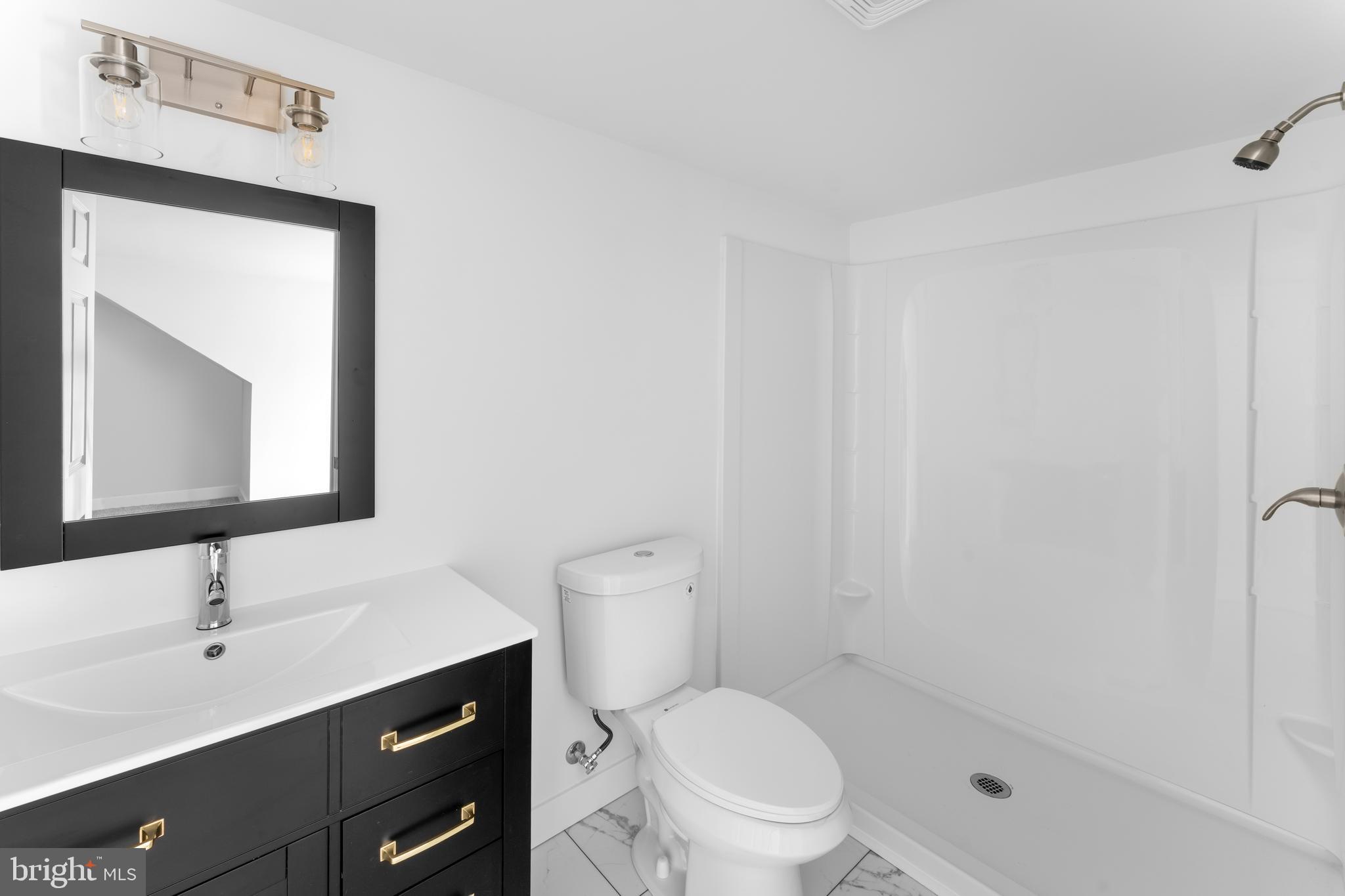 351 Ridgeview Road Gore, VA 22637 - Photo 22 of 31 a bathroom with a toilet a sink a mirror and vanity
