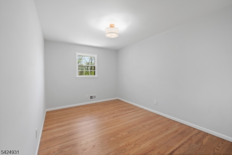 22 Hillcrest Road Hillsborough, NJ 08844 - Photo 17 of 35 an empty room with wooden floor and windows