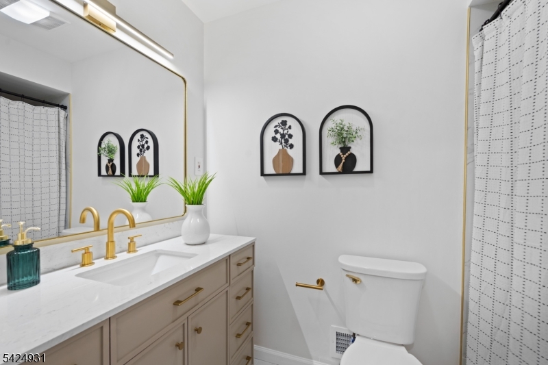 22 Hillcrest Road Hillsborough, NJ 08844 - Photo 18 of 35 a bathroom with a toilet a sink and mirror