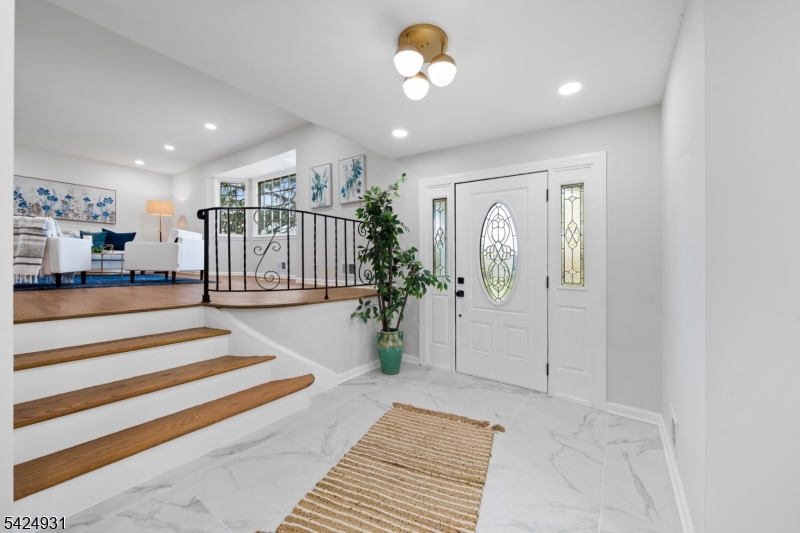 22 Hillcrest Road Hillsborough, NJ 08844 - Photo 19 of 35 a view of a hallway with wooden floor and a chandelier