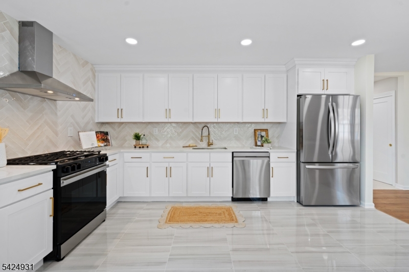 22 Hillcrest Road Hillsborough, NJ 08844 - Photo 2 of 35 a kitchen with a stove a refrigerator and a sink