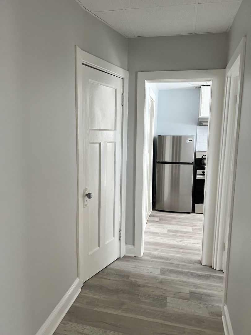1001 Washington Street Evanston, IL 60202 - Photo 7 of 13 a view of empty room with wooden floor and refrigerator