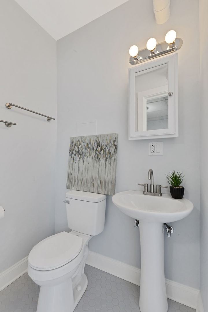 1001 Washington Street Evanston, IL 60202 - Photo 8 of 13 a bathroom with a sink a toilet and mirror