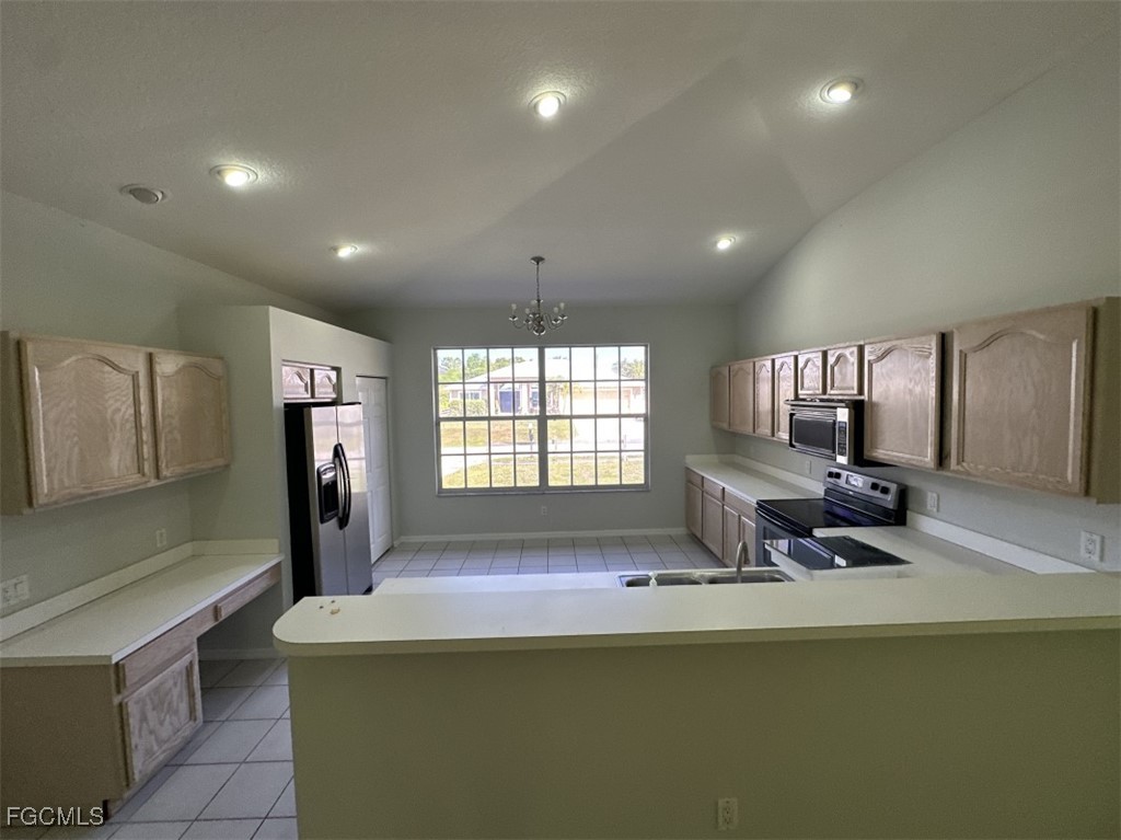 2400 Leavitt Road Alva, FL 33920 - Photo 12 of 26 a dining table chair next to a window and a couch