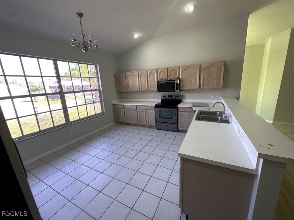 2400 Leavitt Road Alva, FL 33920 - Photo 13 of 26 a kitchen with a sink a window and cabinets