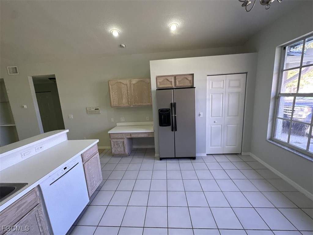2400 Leavitt Road Alva, FL 33920 - Photo 14 of 26 a kitchen with a refrigerator sink and cabinets