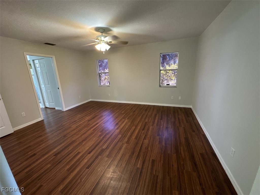 2400 Leavitt Road Alva, FL 33920 - Photo 17 of 26 wooden floor in an empty room with a window