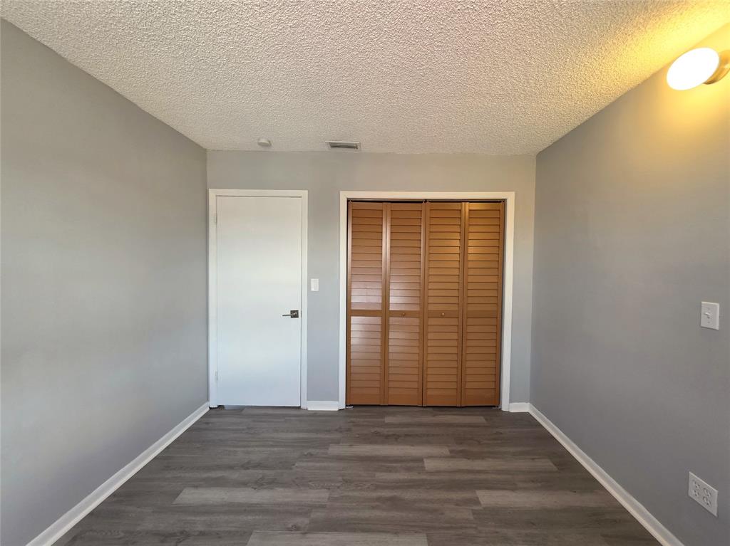 11951 Southwest 271st Terrace Homestead, FL 33032 - Photo 12 of 25 a view of an empty room with wooden floor and a window