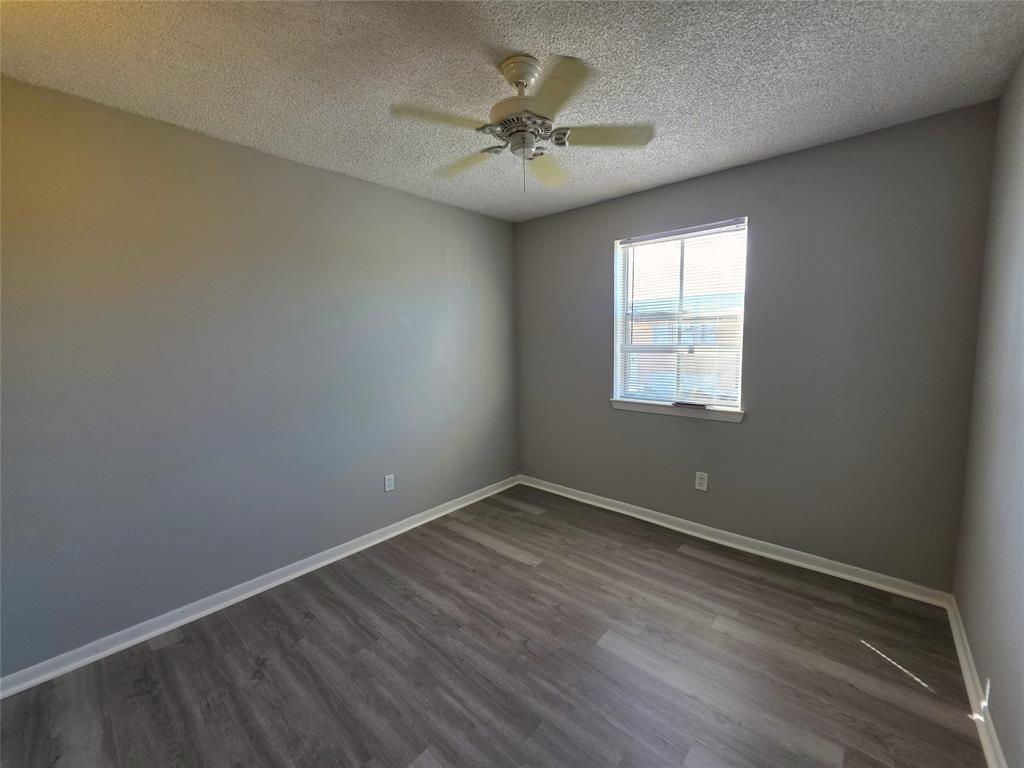 11951 Southwest 271st Terrace Homestead, FL 33032 - Photo 16 of 25 an empty room with a window and a ceiling fan