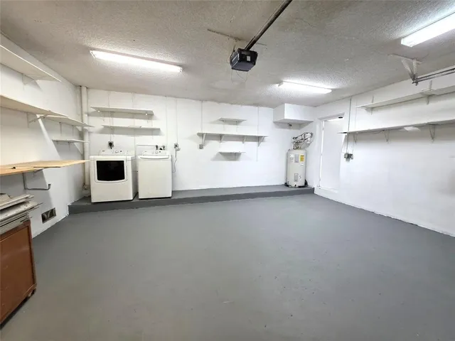 a view of a storage & utility room with cabinets