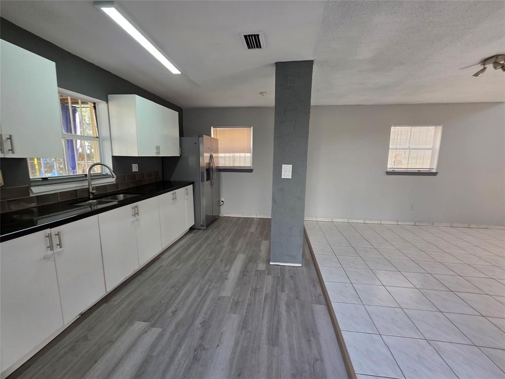 11951 Southwest 271st Terrace Homestead, FL 33032 - Photo 2 of 25 a kitchen with granite countertop a sink stove and cabinets