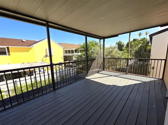 a view of a balcony with wooden floor