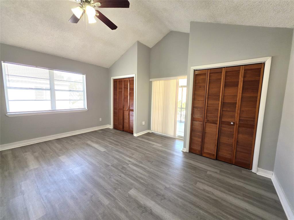 11951 Southwest 271st Terrace Homestead, FL 33032 - Photo 7 of 25 an empty room with wooden floor cabinet and windows