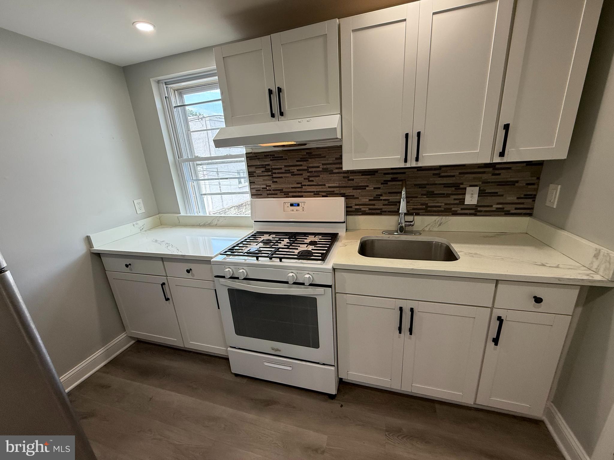 6921 Clinton Road Upper Darby, PA 19082 - Photo 1 of 17 a kitchen with appliances a sink and cabinets