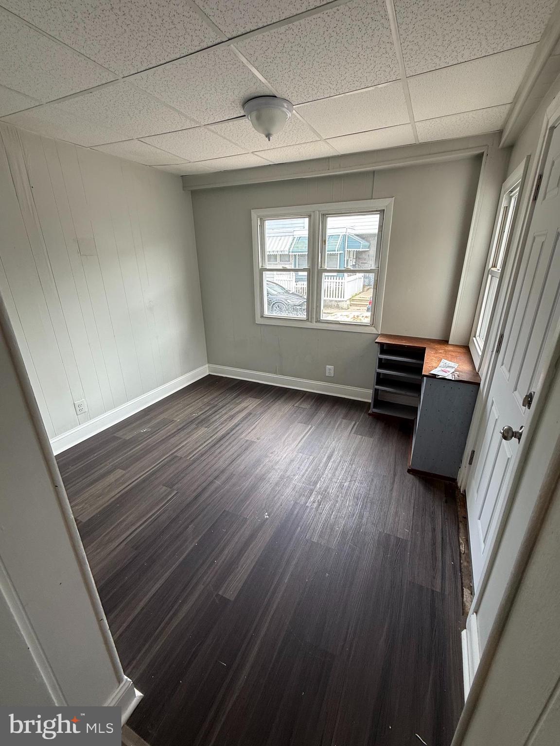 6921 Clinton Road Upper Darby, PA 19082 - Photo 11 of 17 a view of an empty room with wooden floor and a window