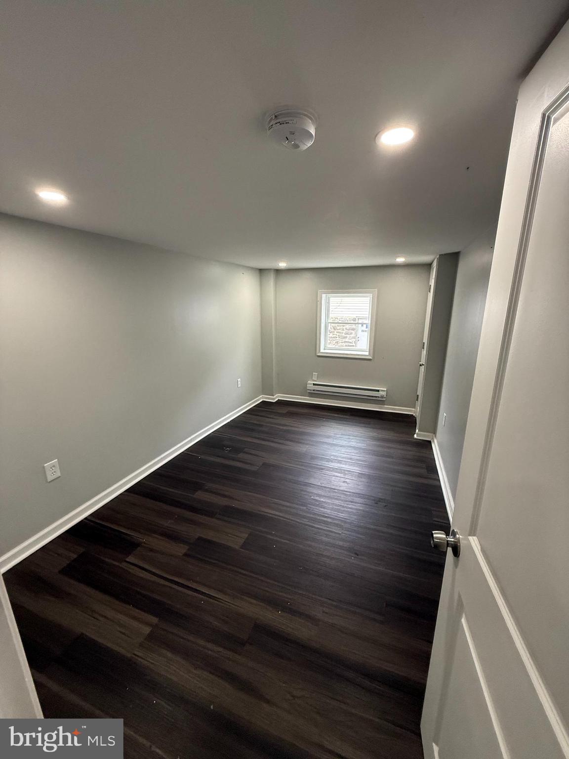 6921 Clinton Road Upper Darby, PA 19082 - Photo 12 of 17 an empty room with wooden floor and windows