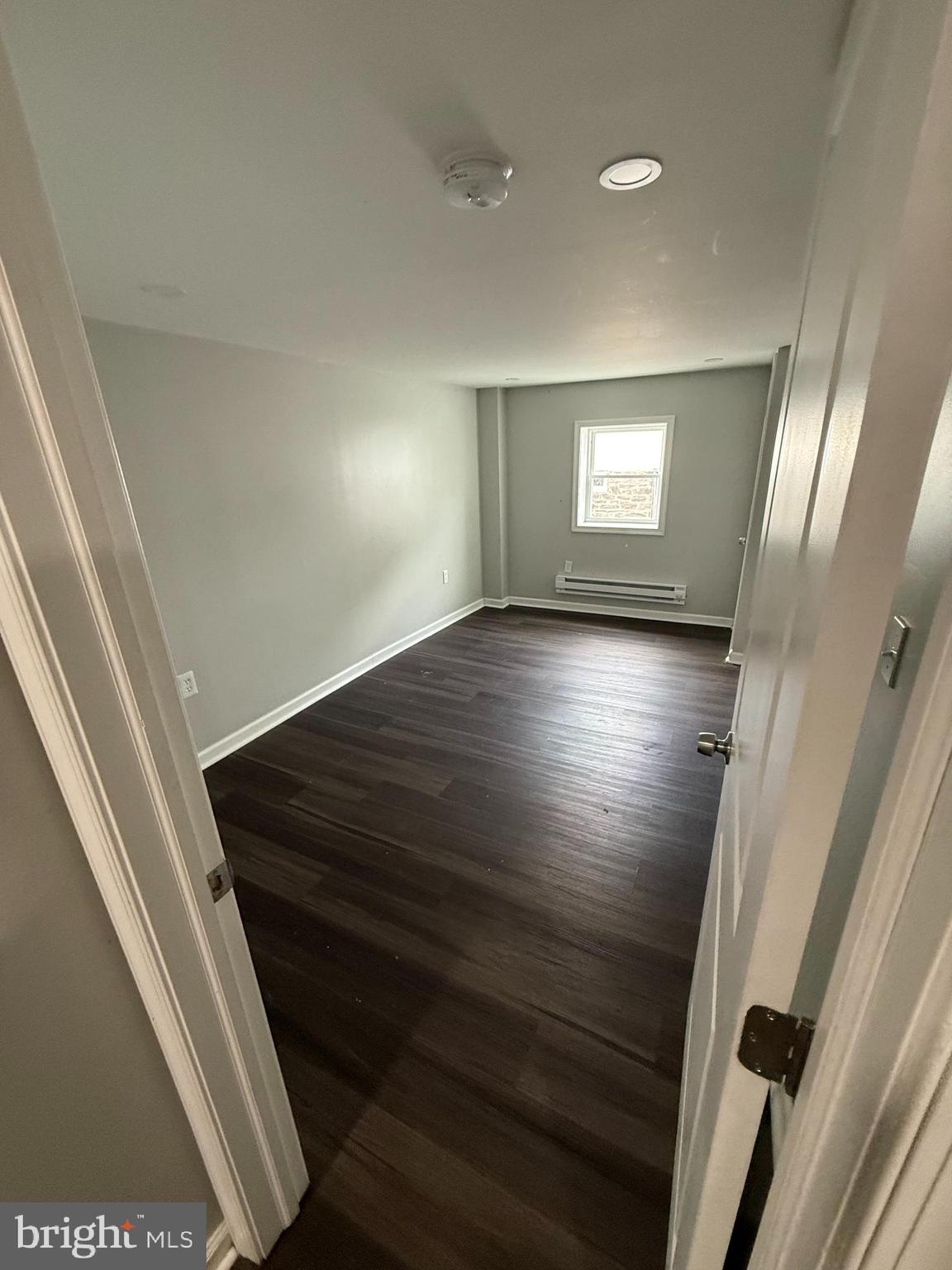 6921 Clinton Road Upper Darby, PA 19082 - Photo 13 of 17 a view of an empty room with wooden floor and stairs