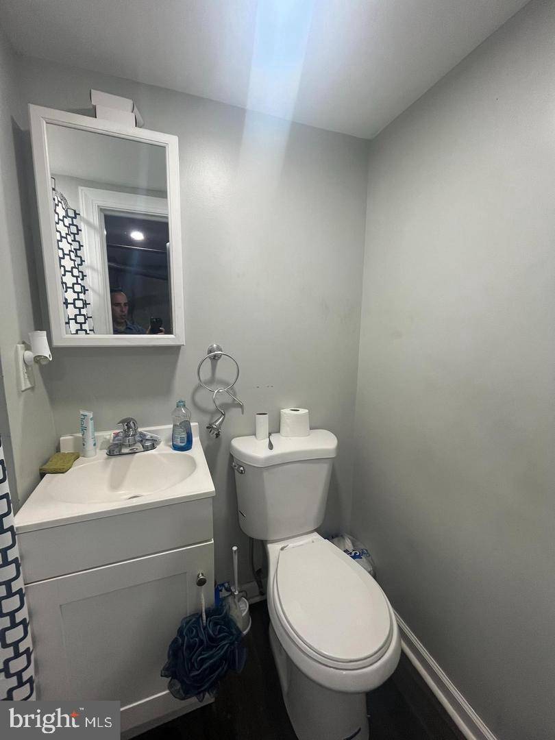 6921 Clinton Road Upper Darby, PA 19082 - Photo 16 of 17 a bathroom with a toilet sink and mirror