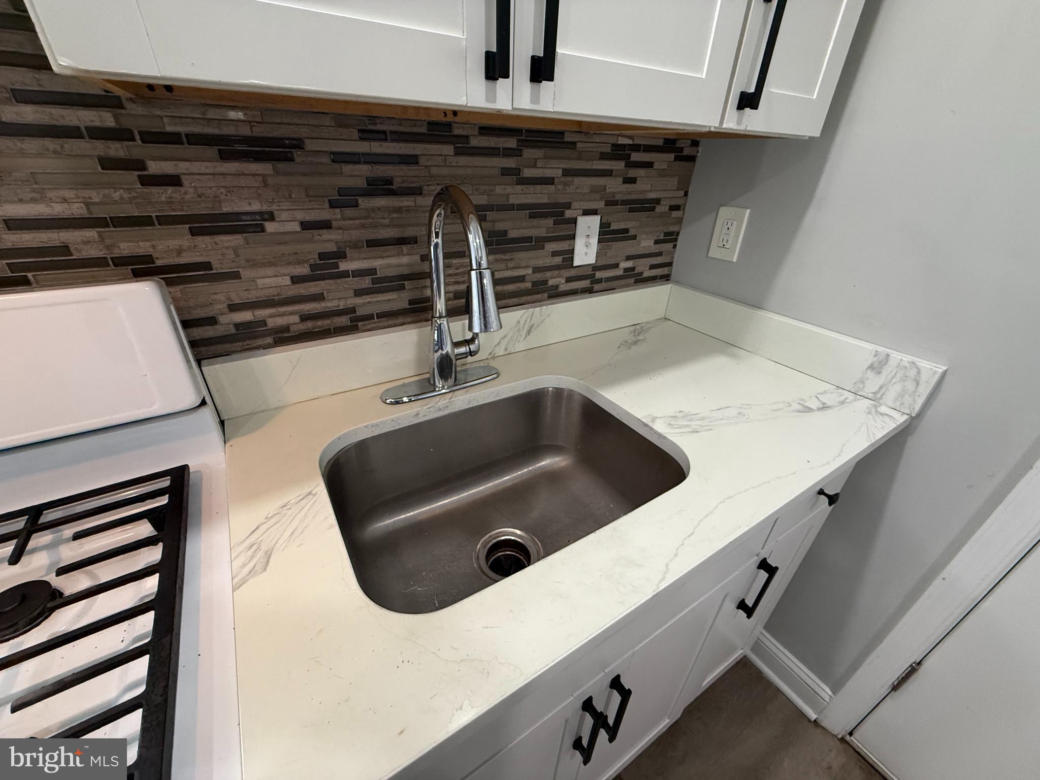 6921 Clinton Road Upper Darby, PA 19082 - Photo 3 of 17 a close view of sink and washing machine