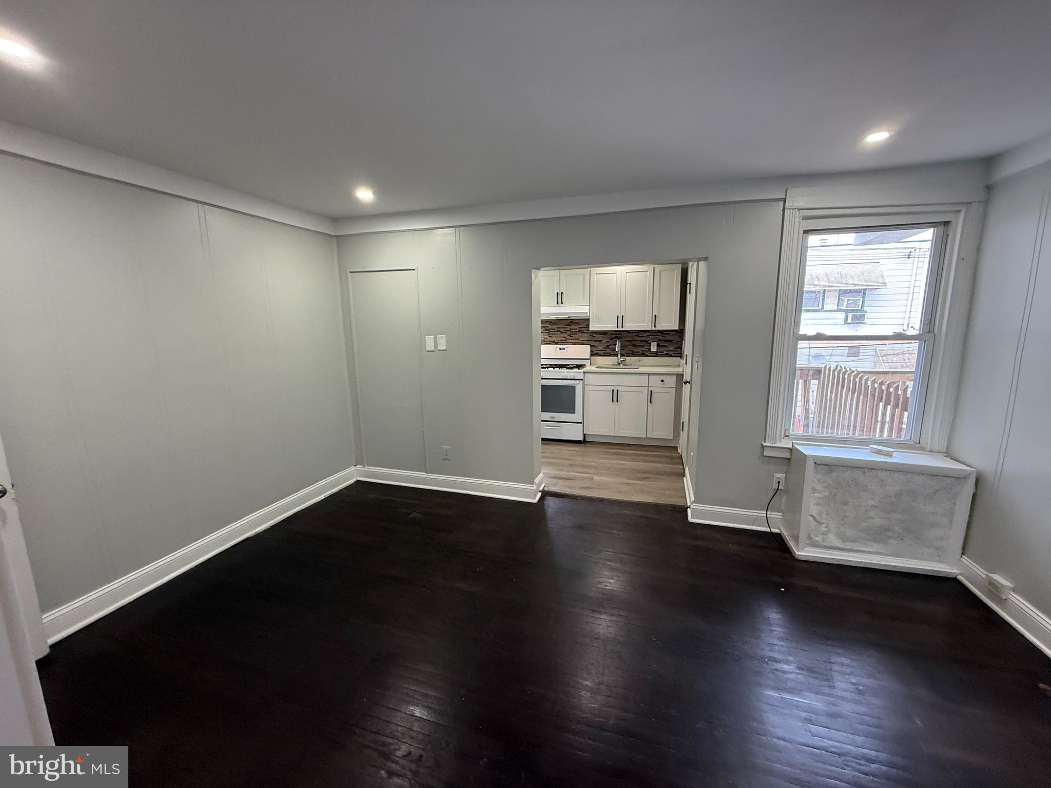 6921 Clinton Road Upper Darby, PA 19082 - Photo 6 of 17 an empty room with wooden floor and windows