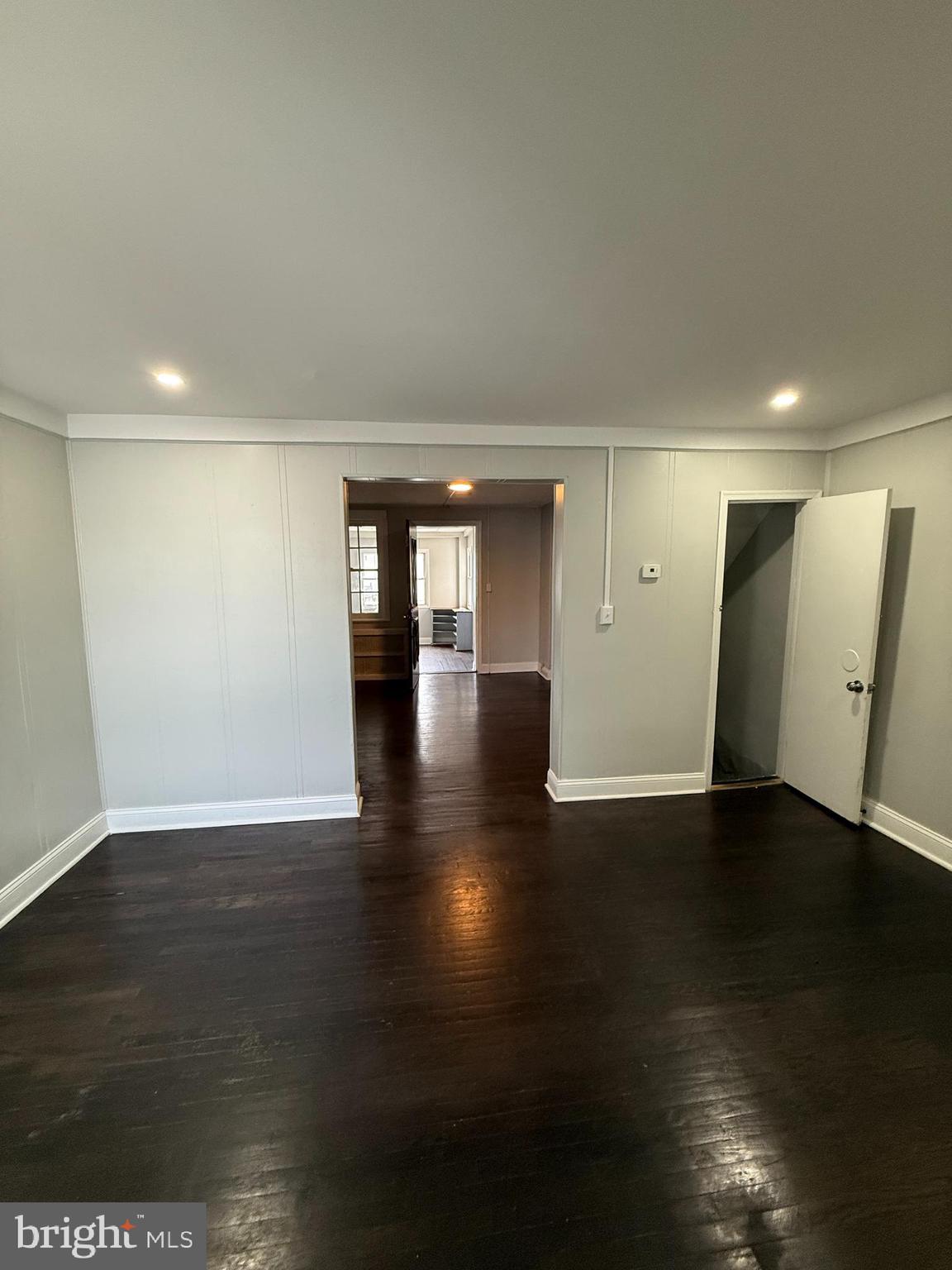 6921 Clinton Road Upper Darby, PA 19082 - Photo 7 of 17 a view of an empty room with wooden floor and a window