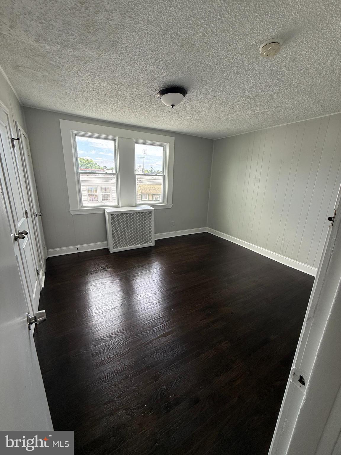 6921 Clinton Road Upper Darby, PA 19082 - Photo 10 of 17 an empty room with wooden floor and windows