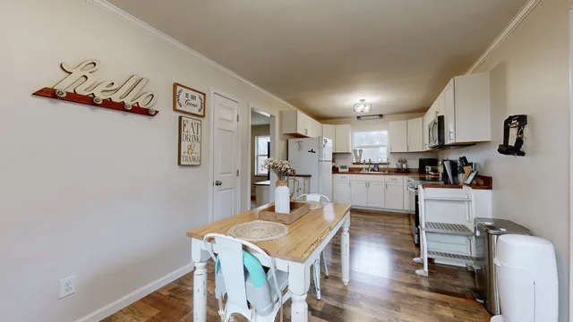 a open kitchen with cabinets table and chairs