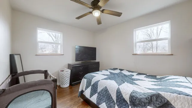 a bedroom with a bed and a chandelier