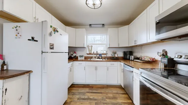 a kitchen with stainless steel appliances granite countertop a refrigerator sink and cabinets
