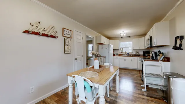 a open kitchen with cabinets stove and refrigerator