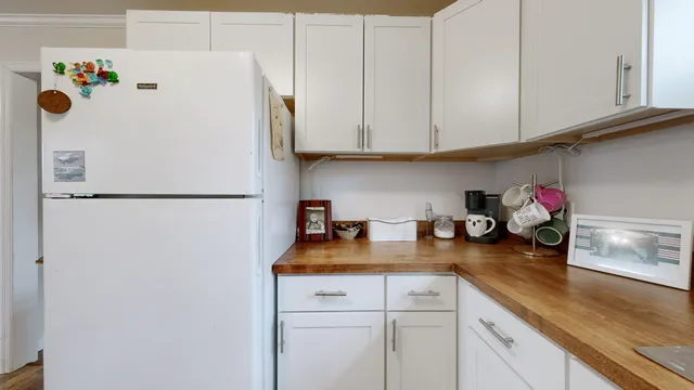 a kitchen with refrigerator and cabinets