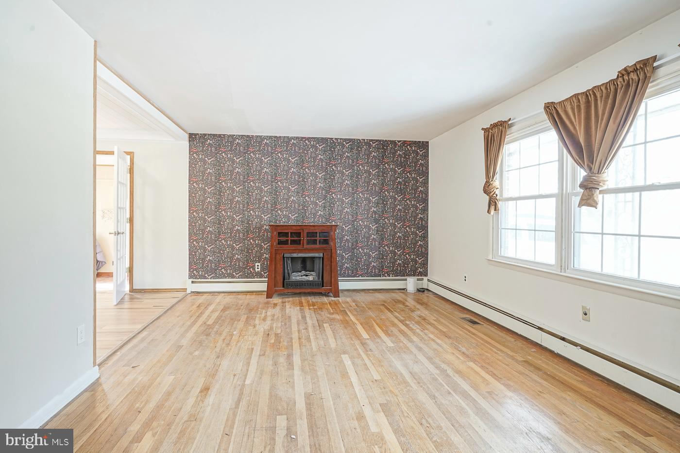 462 Carvin Street Clayton, NJ 08312 - Photo 3 of 29 an empty room with windows and fireplace
