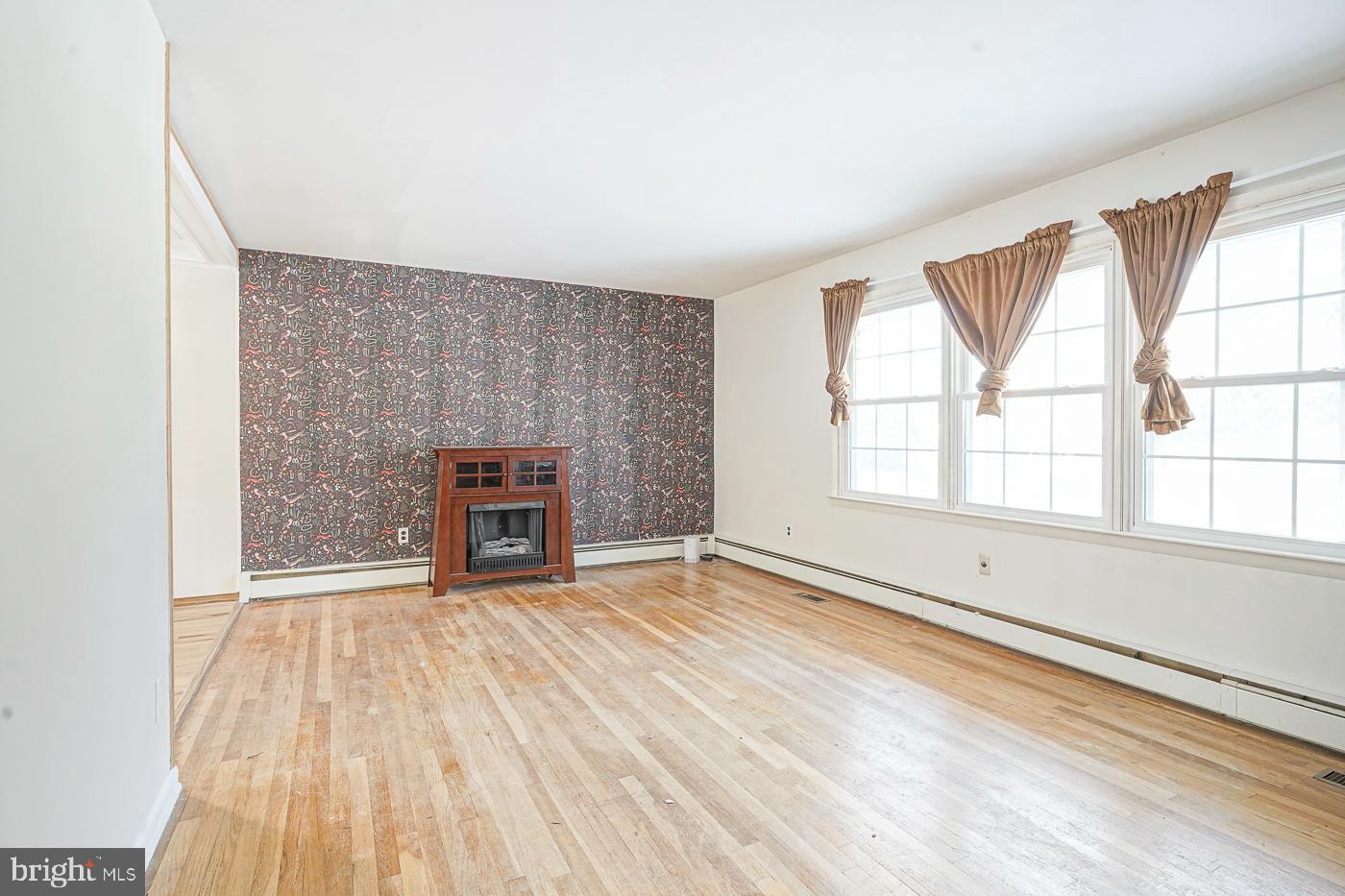 462 Carvin Street Clayton, NJ 08312 - Photo 4 of 29 an empty room with windows and fireplace