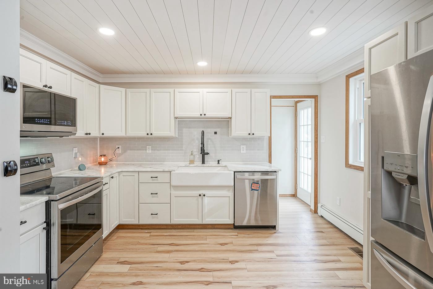 462 Carvin Street Clayton, NJ 08312 - Photo 5 of 29 a kitchen with white cabinets stainless steel appliances and a counter space
