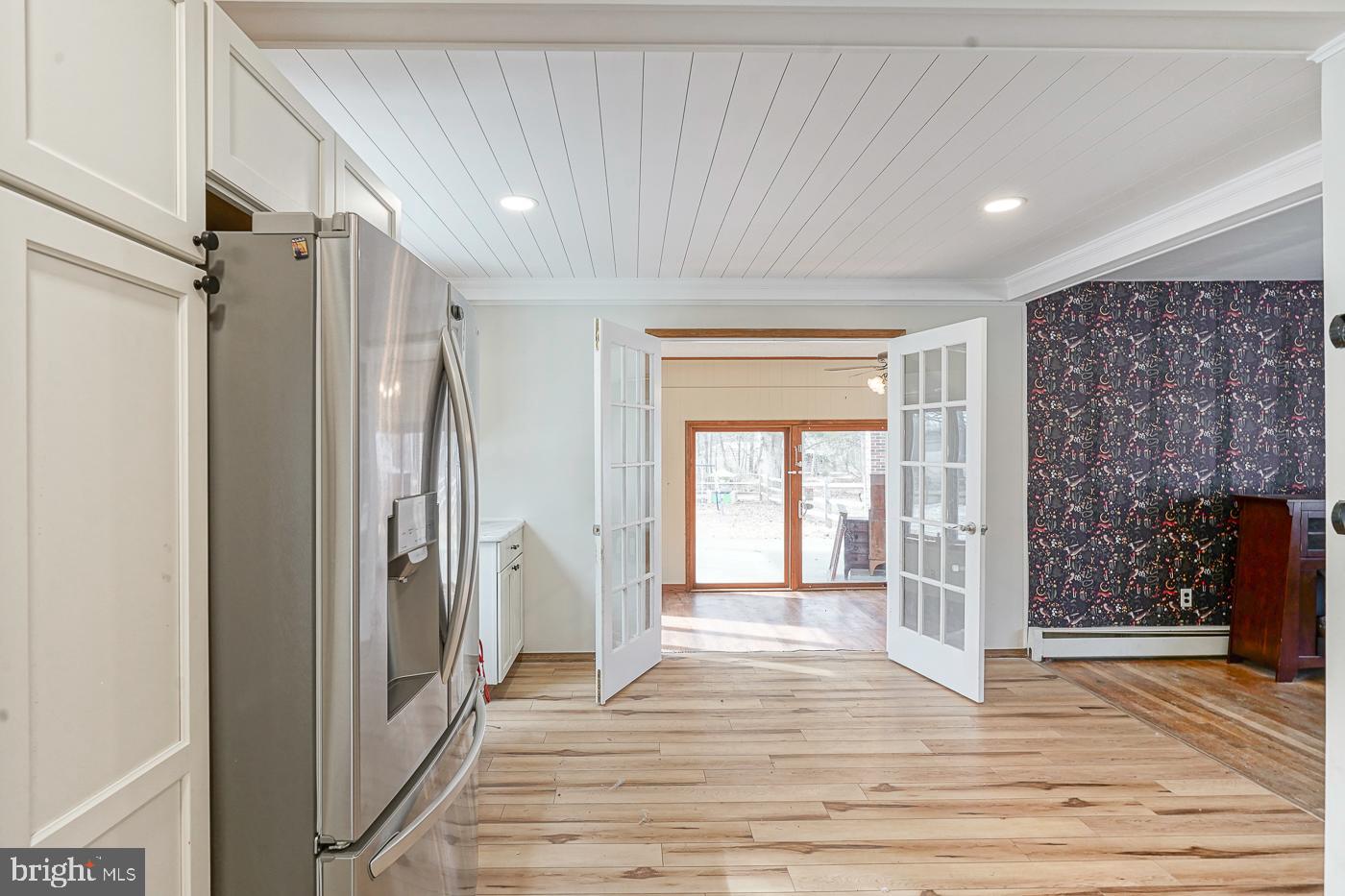 462 Carvin Street Clayton, NJ 08312 - Photo 6 of 29 a view of a hallway with wooden floor and a living room