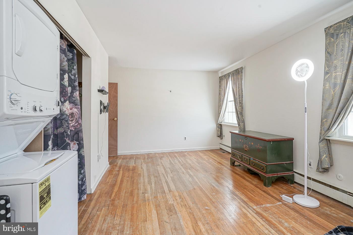 462 Carvin Street Clayton, NJ 08312 - Photo 9 of 29 a view of an empty room with wooden floor and a fireplace