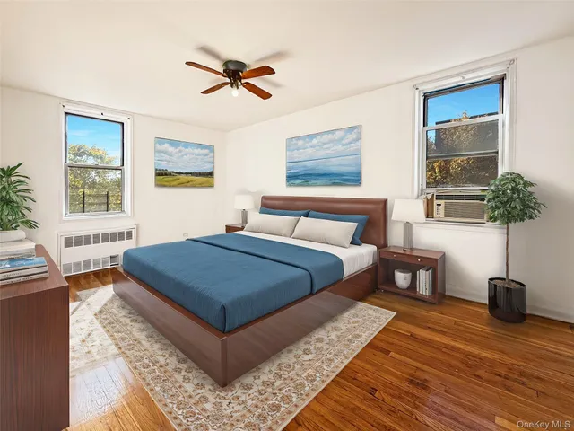 a bedroom with a bed a table and potted plant