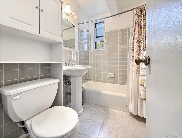 a bathroom with a toilet a sink and bathtub