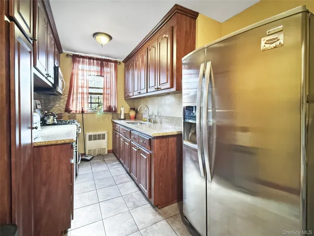 a kitchen with stainless steel appliances granite countertop a refrigerator and a stove