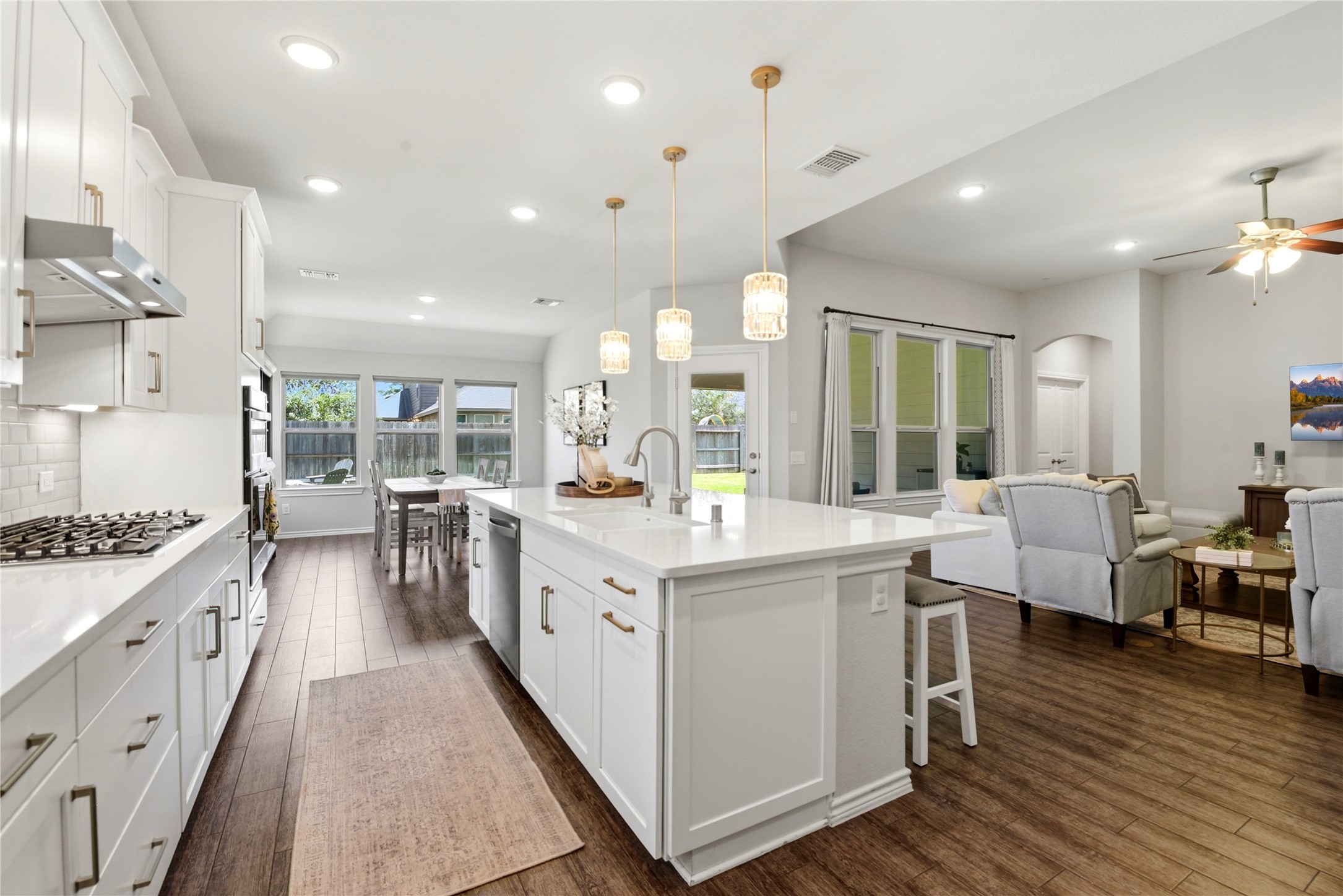 17834 Maple Ash Drive Spring, TX 77379 - Photo 15 of 50 Kitchen space seamlessly flows into a cozy living room with ample natural light and a view of the backyard through large windows. Ideal for entertaining and family living.