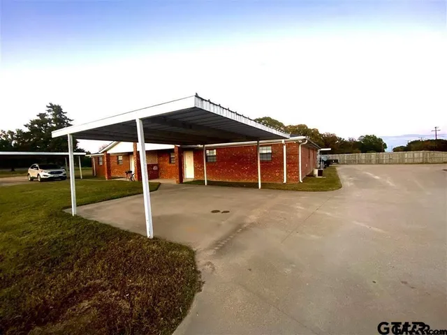a view of a table and chairs under an umbrella