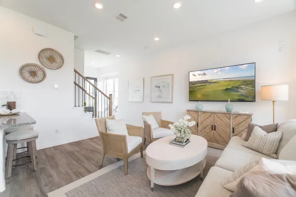 a living room with furniture kitchen and a table