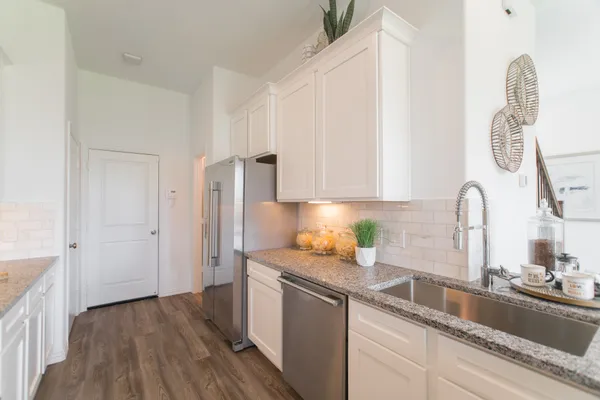 a kitchen with stainless steel appliances a stove a microwave and cabinets