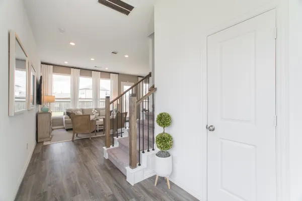 a view of entryway and hall with wooden floor