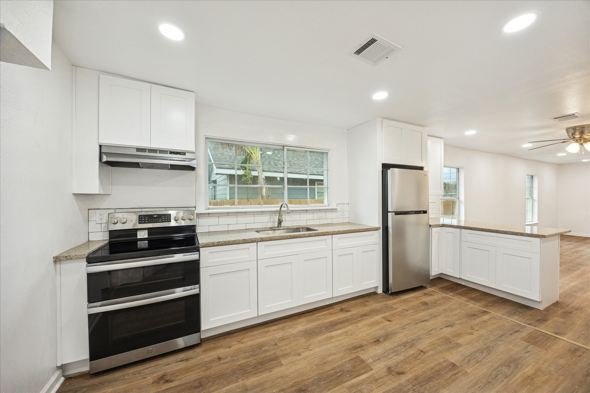 1803 Simpson Street Houston, TX 77020 - Photo 3 of 10 a kitchen with refrigerator cabinets and a stove