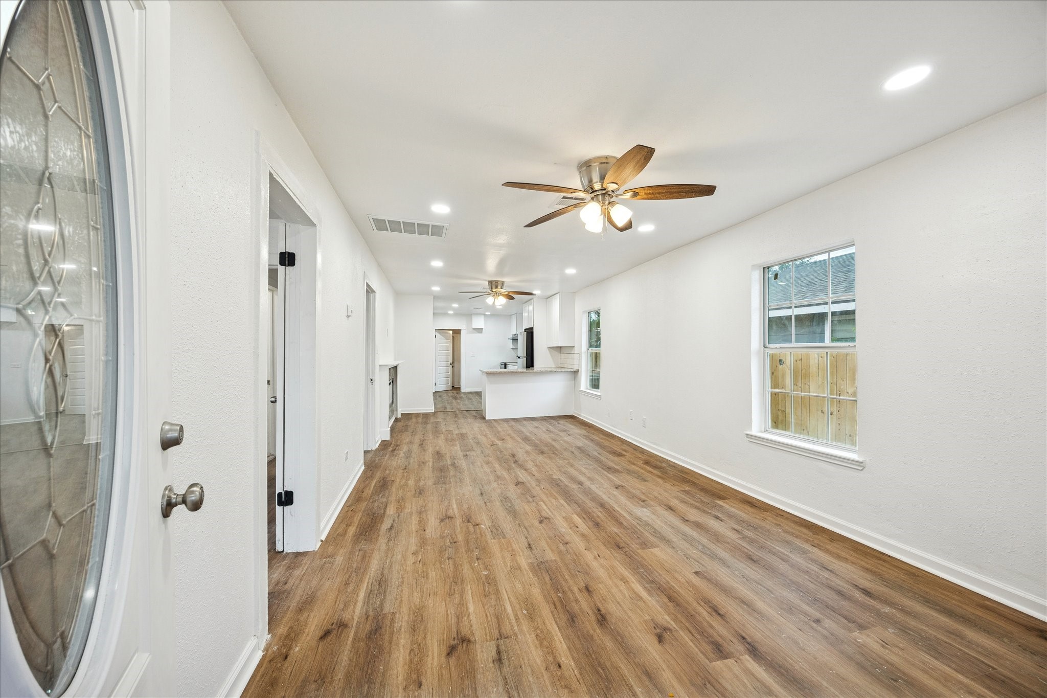 1803 Simpson Street Houston, TX 77020 - Photo 5 of 10 wooden floor in an empty room with a window