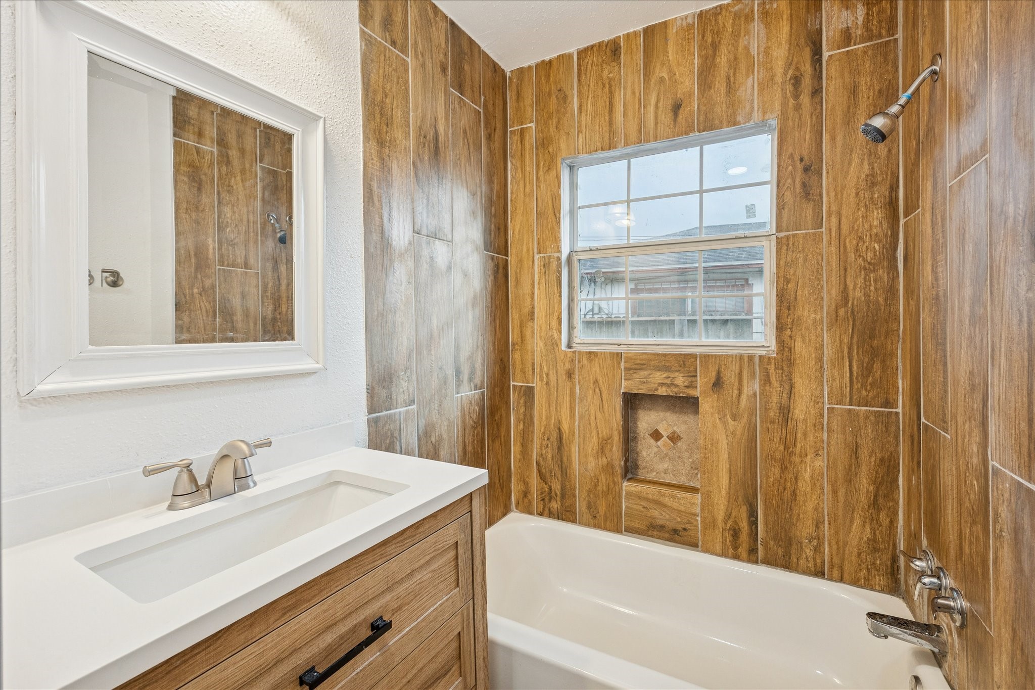 1803 Simpson Street Houston, TX 77020 - Photo 10 of 10 a bathroom with a sink vanity tub and a mirror