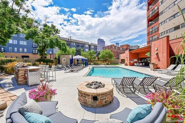 a view of a patio with couches table and chairs and potted plants