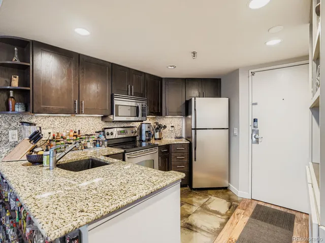 a kitchen with a refrigerator and a sink
