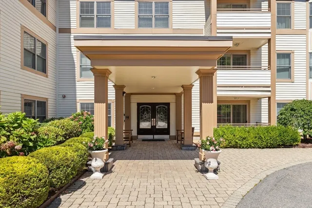 a view of a house with potted plants